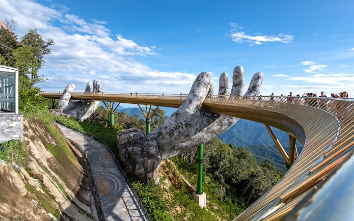 Golden Bridge held by giant hands at Sun World Ba Na Hills, Vietnam.