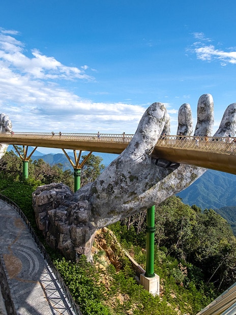 Golden Bridge held by giant hands at Sun World Ba Na Hills, Vietnam.