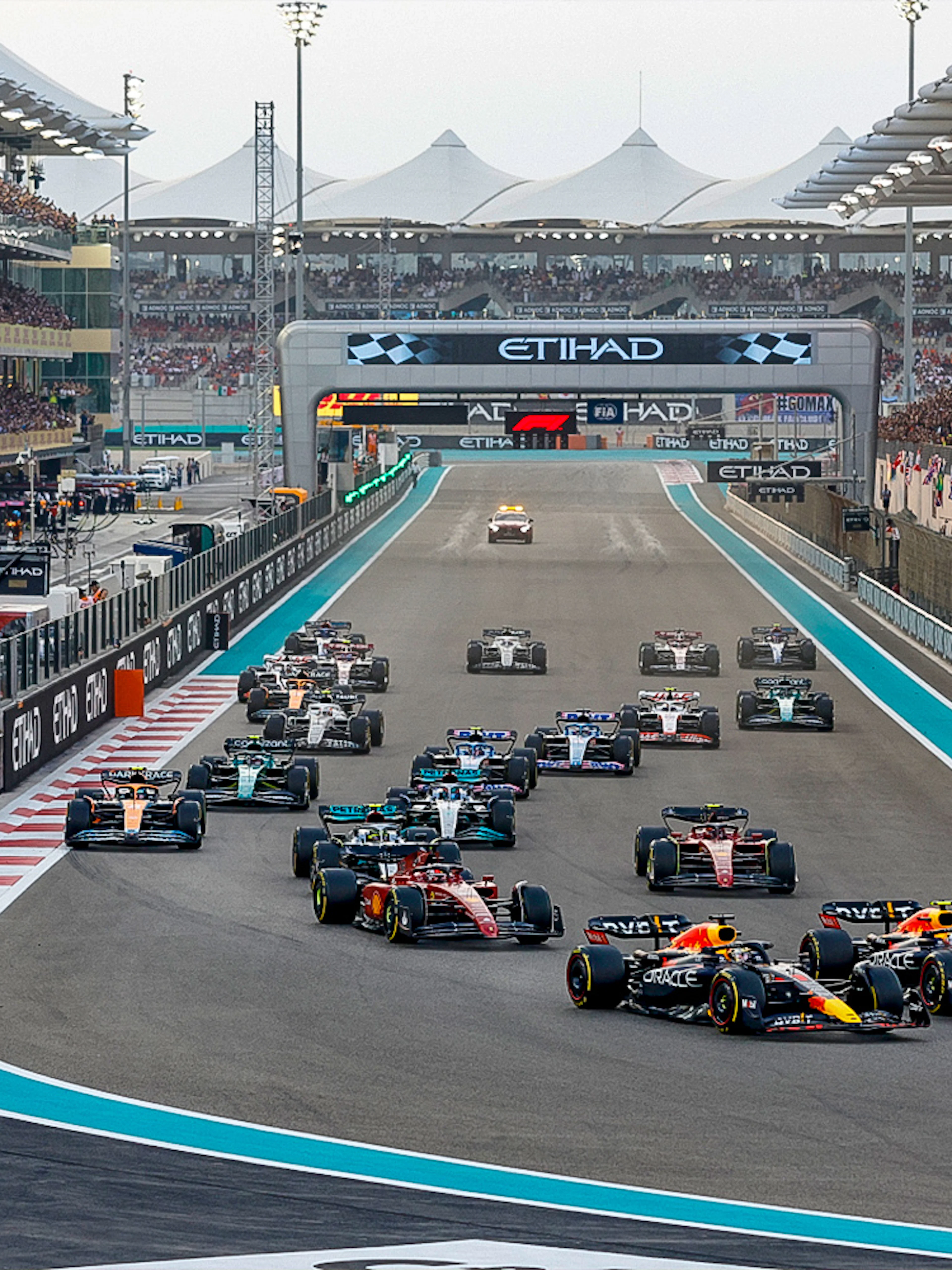 Formula 1 cars racing at the Abu Dhabi Grand Prix, Yas Marina Circuit.