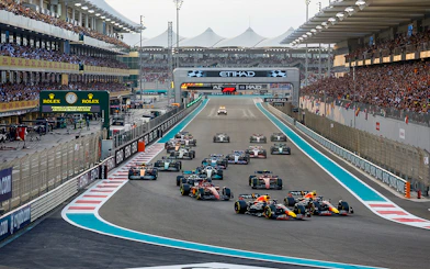 Formula 1 cars racing at the Abu Dhabi Grand Prix, Yas Marina Circuit.