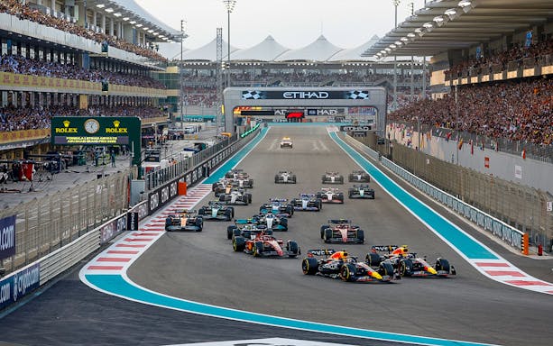 Formula 1 cars racing at the Abu Dhabi Grand Prix, Yas Marina Circuit.