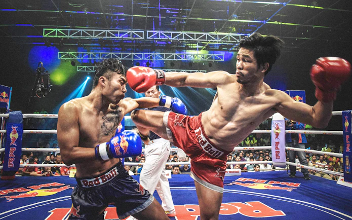 Muay Thai fighters in action at Chiang Mai Boxing Stadium.