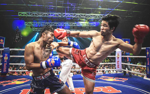Muay Thai fighters in action at Chiang Mai Boxing Stadium.