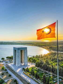 Gallipoli Peninsula, First World War Martyrs Monument with Turkish flag at sunset.