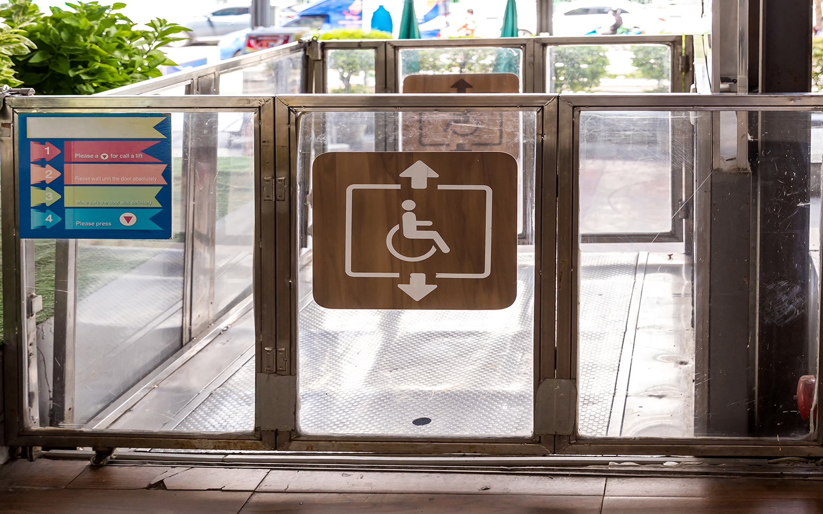 Wheelchair accessibility sign on a lift gate with instructions.
