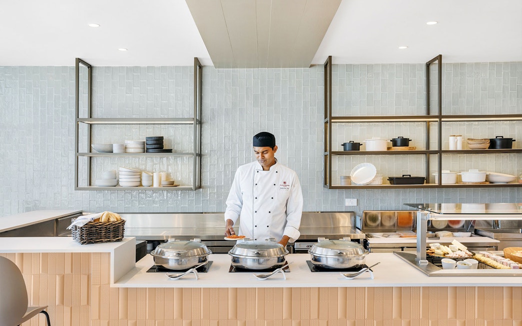 Chef preparing food at Plaza Premium Lounge, International Arrival.