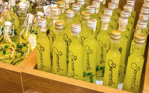 Bottles of limoncello labeled "Sorrento" at a local shop.