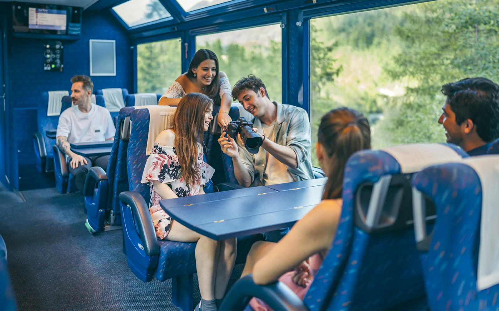 Friends relaxing in second class seats on the Golden Pass train, Switzerland.