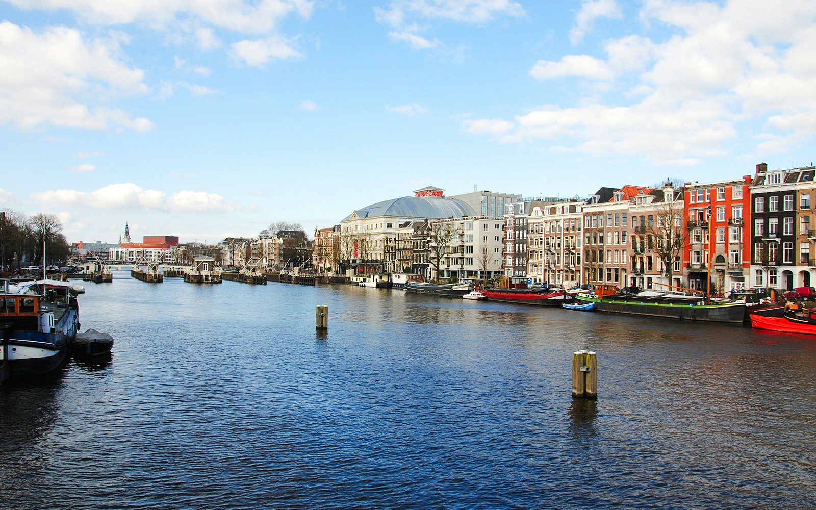 Canal view with historic buildings and boats in Old City Locks, Amsterdam.