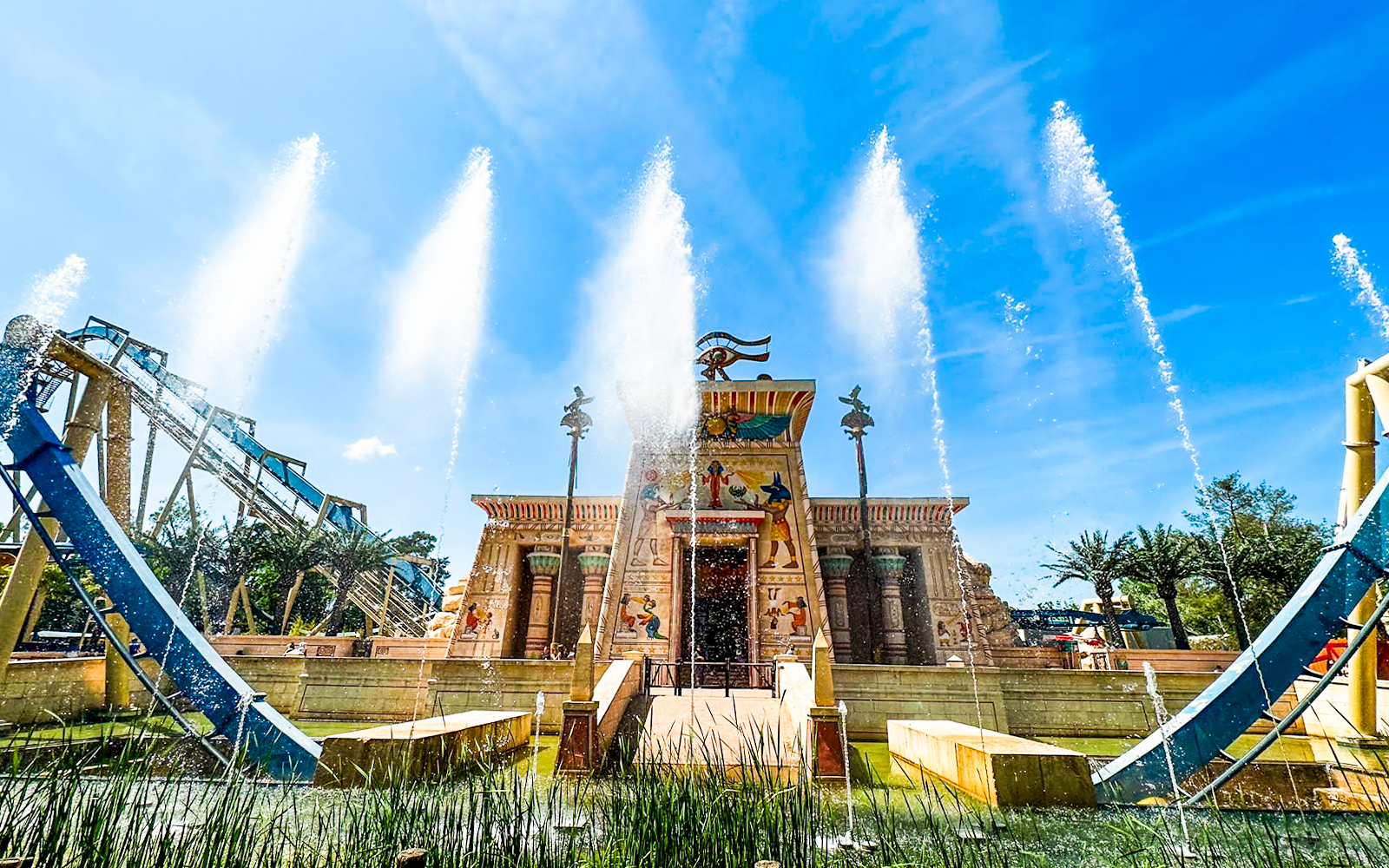 Thrilling OzIris roller coaster ride at Parc Asterix, Paris with excited tourists enjoying the loop