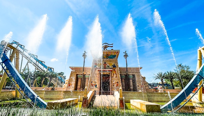 Thrilling OzIris roller coaster ride at Parc Asterix, Paris with excited tourists enjoying the loop