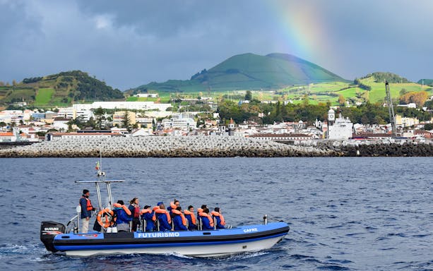 Boat with tourists on a whale and dolphin watching tour near Ponta Delgada, Azores.