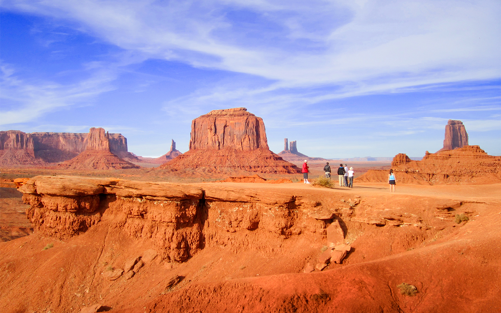 Hikers admiring Monument Valley's buttes, Arizona.