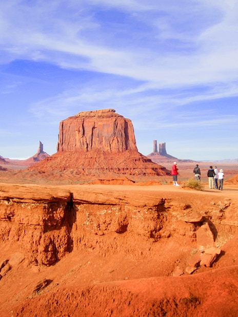 Hikers admiring Monument Valley's buttes, Arizona.