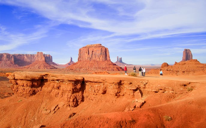 Hikers admiring Monument Valley's buttes, Arizona.