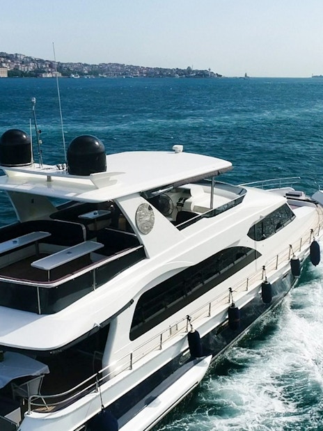 Bosphorus cruise boat sailing near Istanbul coastline.