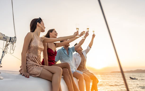 Group enjoying drinks on a Split Riviera cruise at sunset.