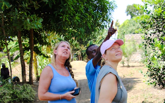 Tourists observing nature during a Giriama cultural village tour in Diani Beach.