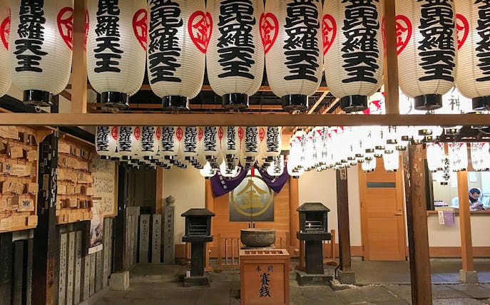 Lanterns hanging in a traditional Osaka shrine during a night food tour.