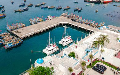 Aerial view of Da Nang harbor with boats and white buildings on the Da Nang Coastal Charm Half-Day Cafe Tour.