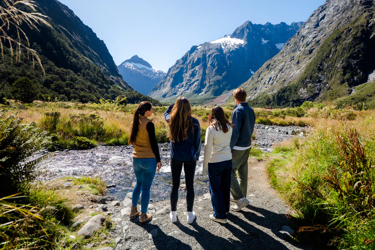 Group exploring Milford Sound landscape on a guided tour from Te Anau.