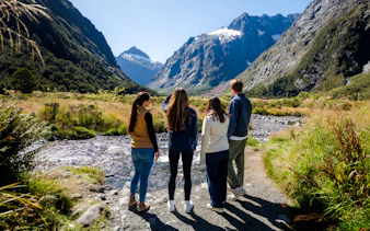Group exploring Milford Sound landscape on a guided tour from Te Anau.