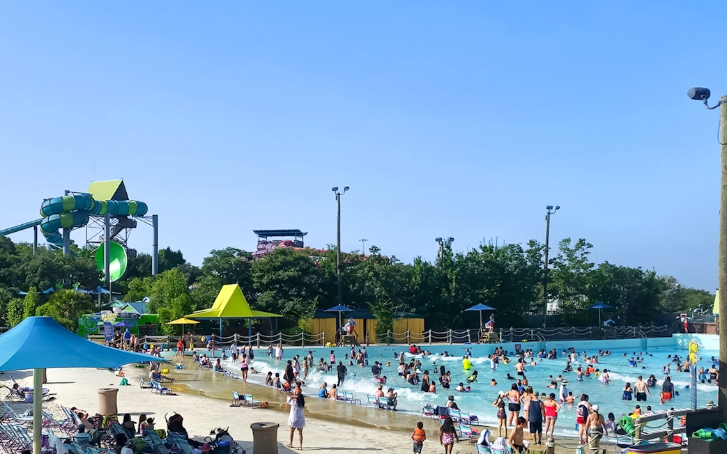Guests enjoying the wave pool at Aquatica San Antonio, Texas.