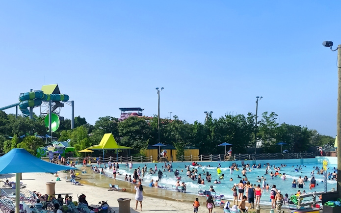 Guests enjoying the wave pool at Aquatica San Antonio, Texas.