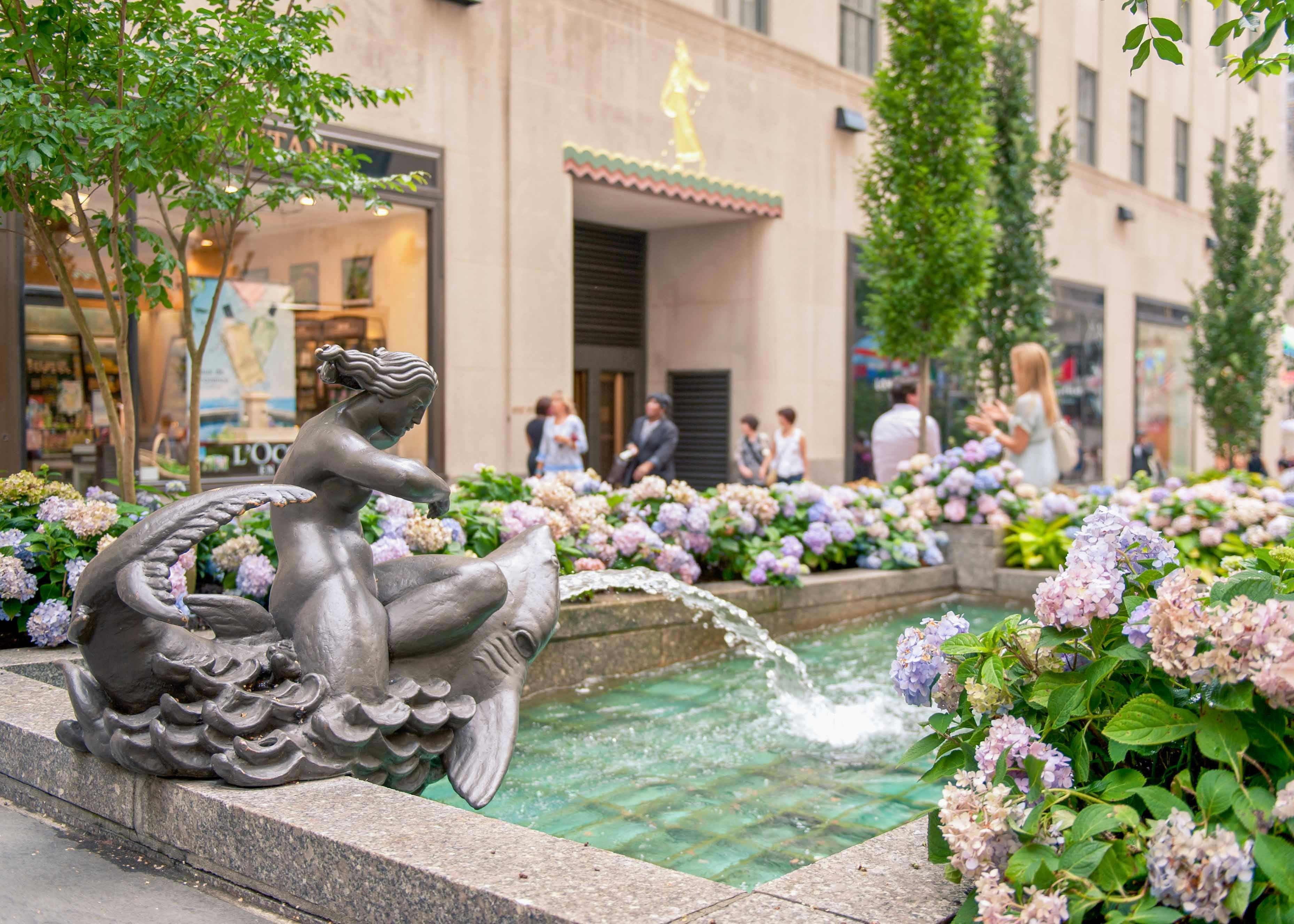 Channel Gardens at Rockefeller Center with vibrant floral displays and iconic Prometheus statue in New York City.