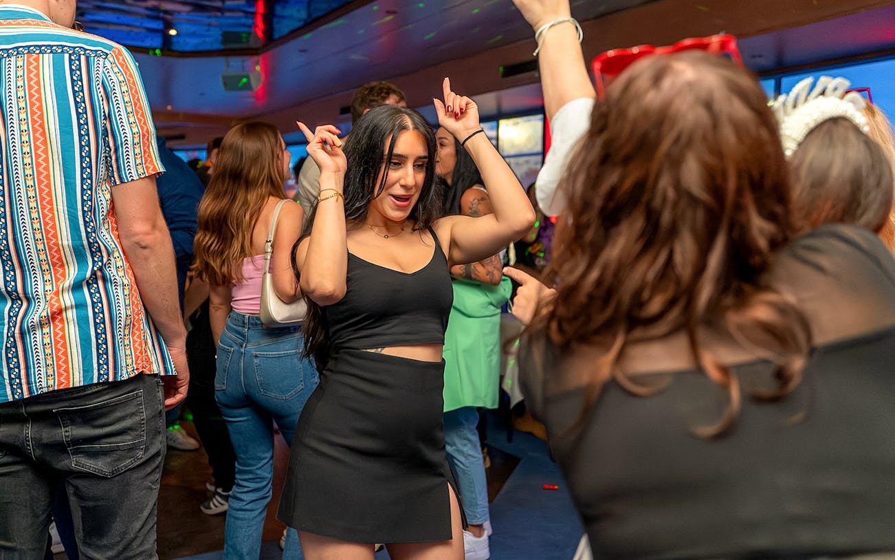 Partygoers dancing on a boat during Hamburg's Friday and Saturday night boat party.