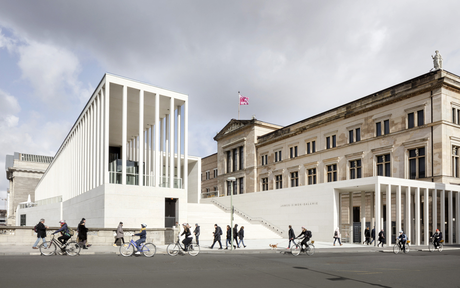 James-Simon-Galerie in Berlin with cyclists and pedestrians in front.