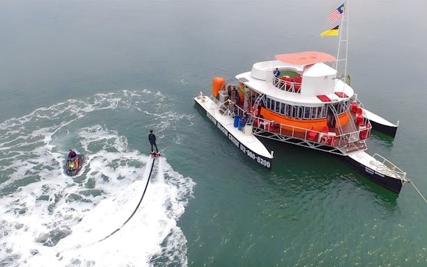 Flyboarder near Dickson Dragon Cruise boat at Port Dickson.