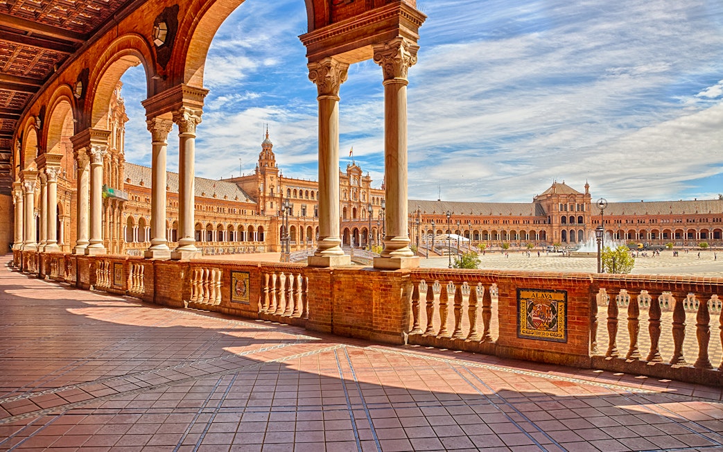 Spain Square in Seville with arched walkways and central fountain.
