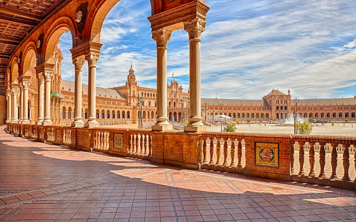 Spain Square in Seville with arched walkways and central fountain.