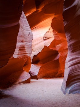 Antelope Canyon X Slot Canyon with sunlight on sandstone walls, Navajo Nation, Arizona.
