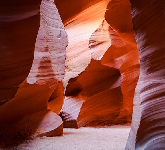Antelope Canyon X Slot Canyon with sunlight on sandstone walls, Navajo Nation, Arizona.