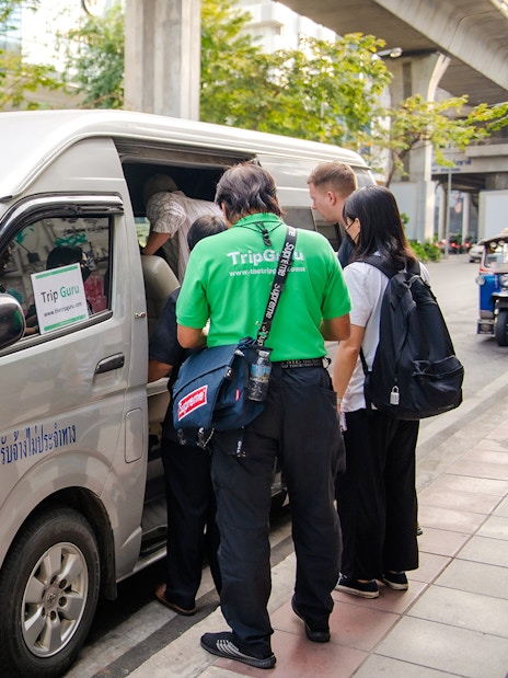Tourists boarding a van for Ayutthaya historical temples tour transfer.