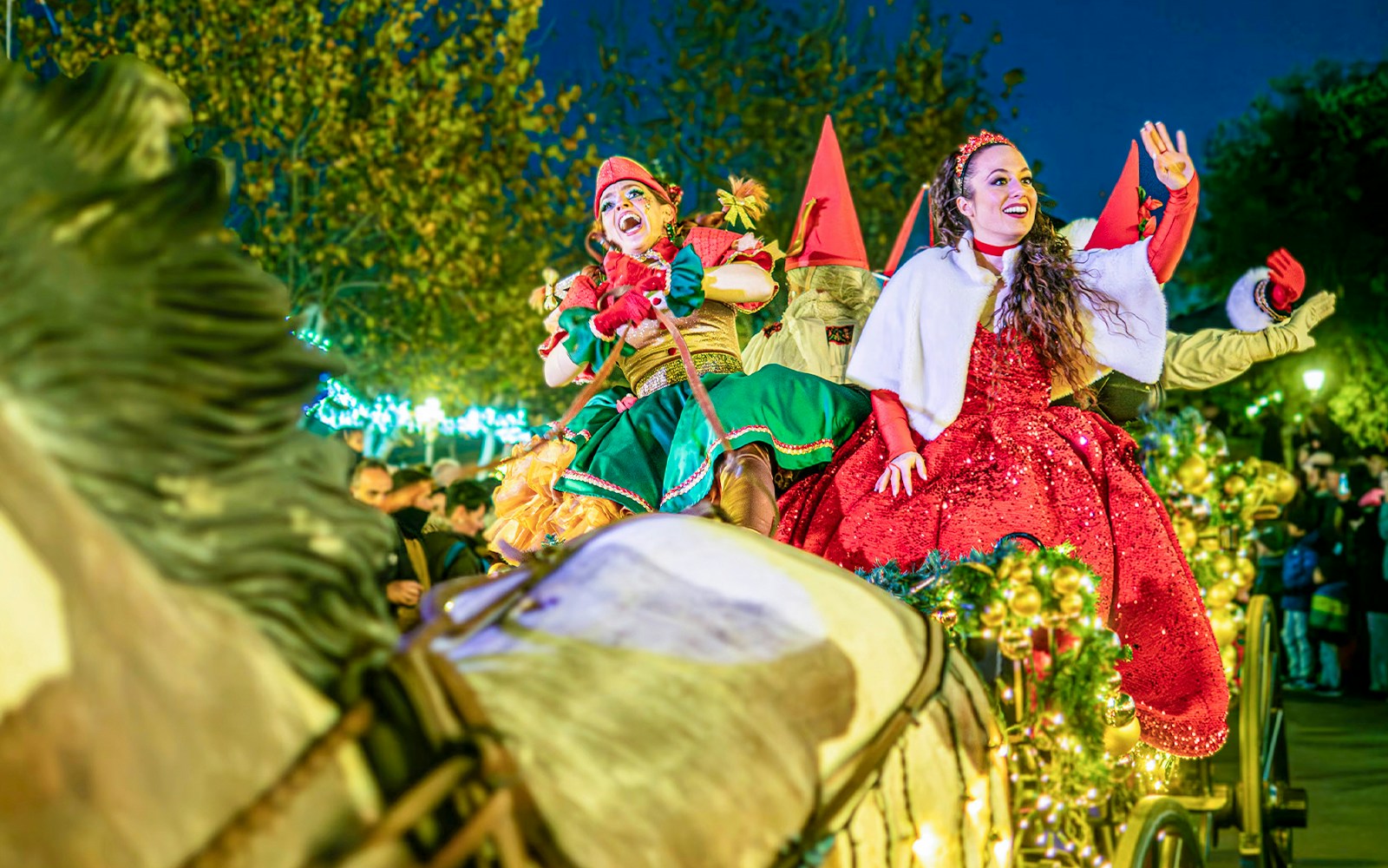 PortAventura Christmas Parade with festive floats and performers in Santa hats, Salou, Spain.