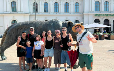 Group posing by the tiger statue at Oslo Central Station during Oslo Walking Tour.