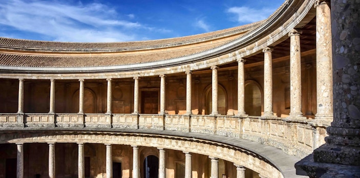 Palace of Charles V interior courtyard with stone columns in Granada, Spain.