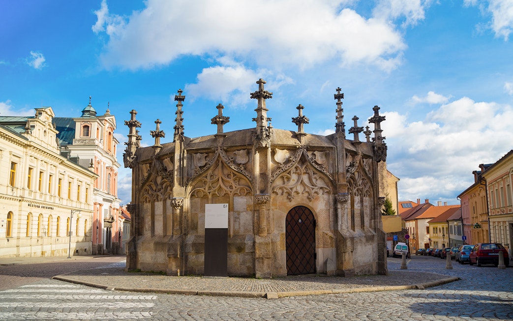 Gothic Stone Fountain in Kutna Hora, Czech Republic, on a cobblestone street.