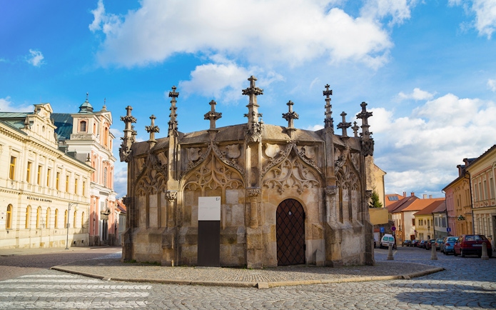 Gothic Stone Fountain in Kutna Hora, Czech Republic, on a cobblestone street.