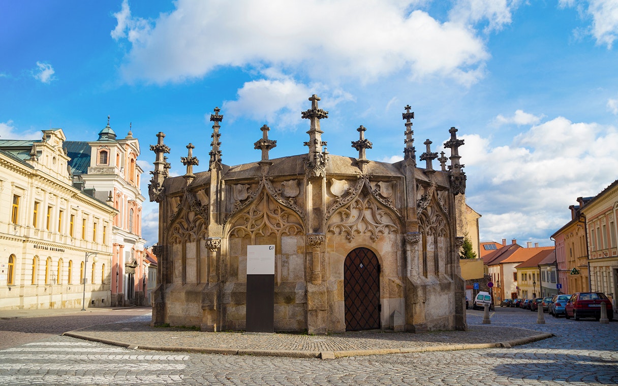 Gothic Stone Fountain in Kutna Hora, Czech Republic, on a cobblestone street.