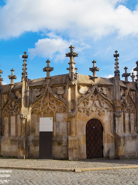 Gothic Stone Fountain in Kutna Hora, Czech Republic, on a cobblestone street.