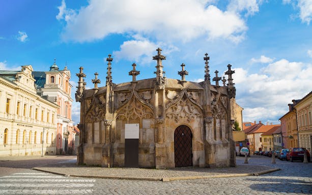 Gothic Stone Fountain in Kutna Hora, Czech Republic, on a cobblestone street.