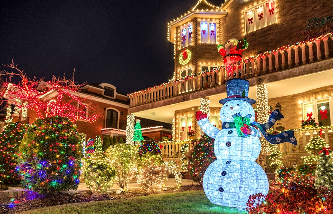 Dyker Heights Christmas lights display viewed from a bus tour in New York City.