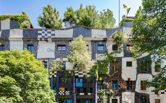 KUNST HAUS WIEN facade with colorful windows and greenery in Vienna.