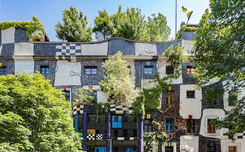 KUNST HAUS WIEN facade with colorful windows and greenery in Vienna.