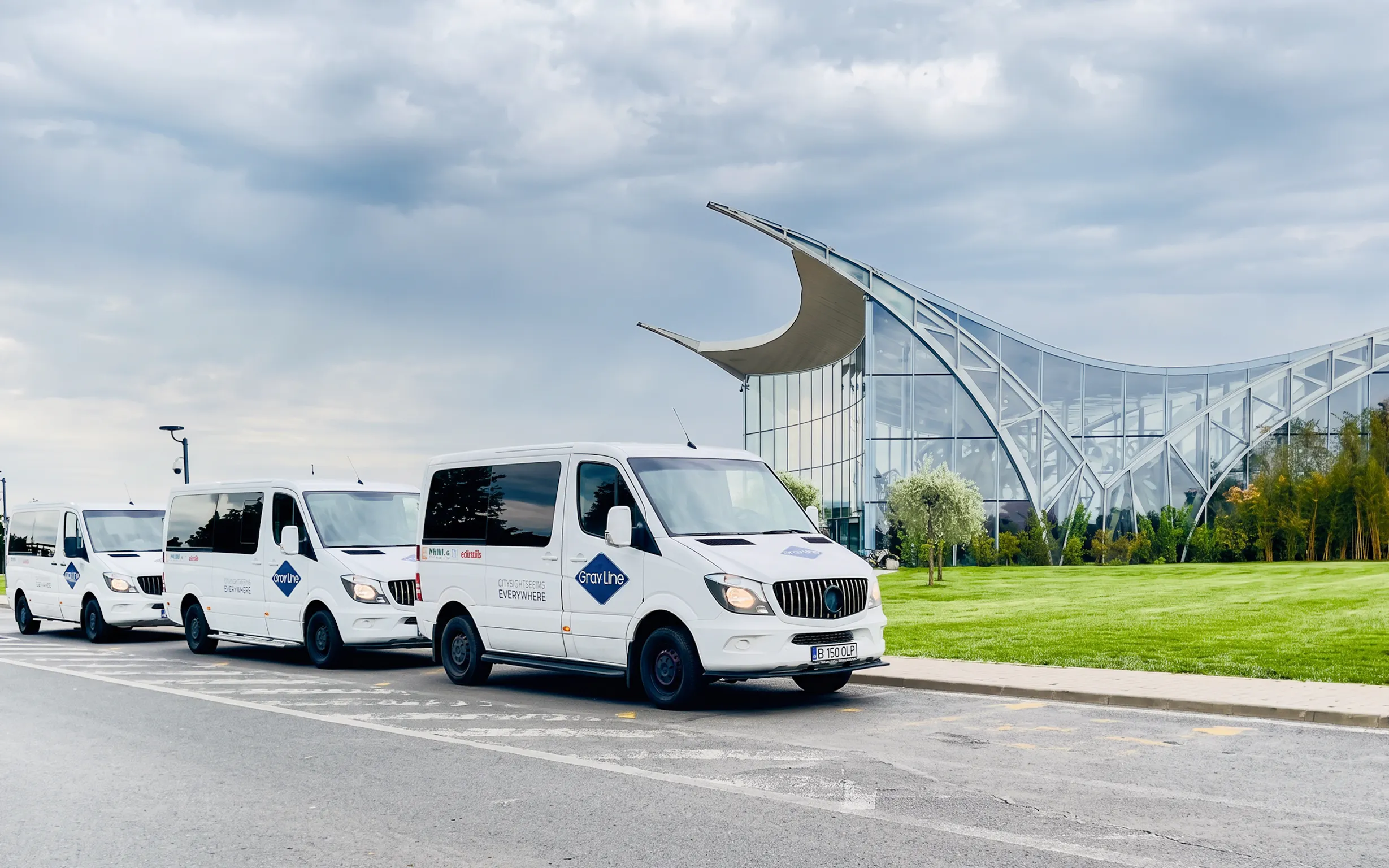 Shuttle vans parked outside Therme Bucuresti for express transfer service.