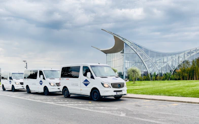 Shuttle vans parked outside Therme Bucuresti for express transfer service.